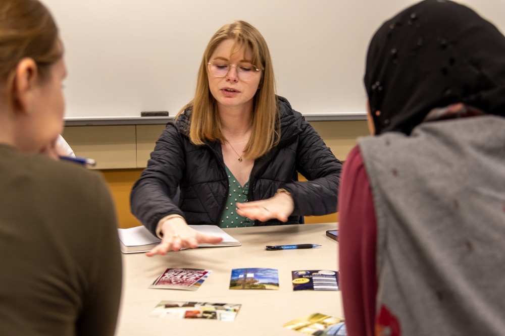 Three people looking at photos